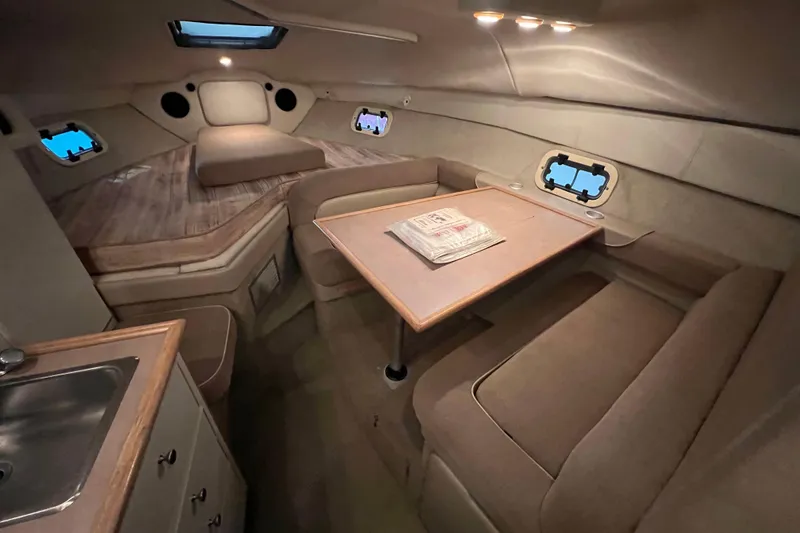 Slide: The Image of Interior of 1997 Maxum 2800 SCR boat with cozy seating and table. - 13