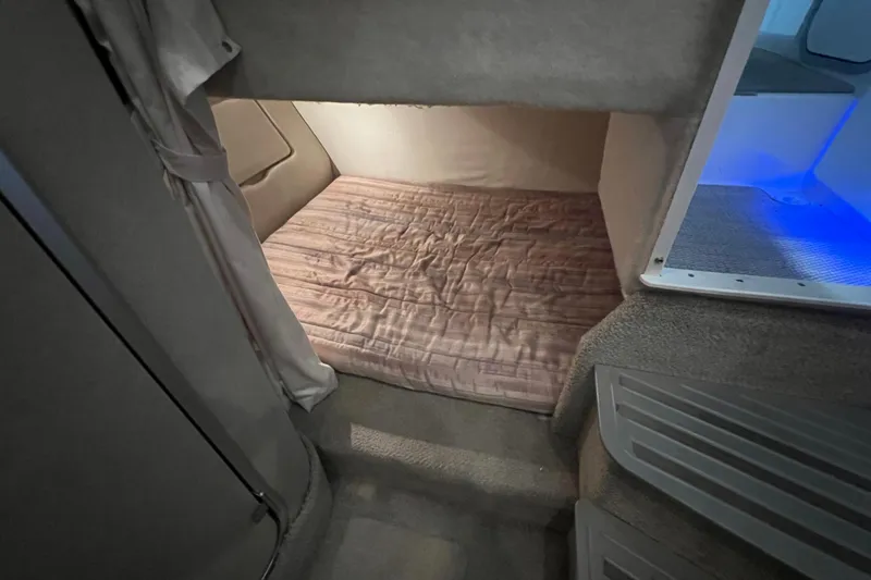 Slide: The Image of 1997 Maxum 2800 SCR cabin interior with cozy sleeping area and soft lighting. - 16