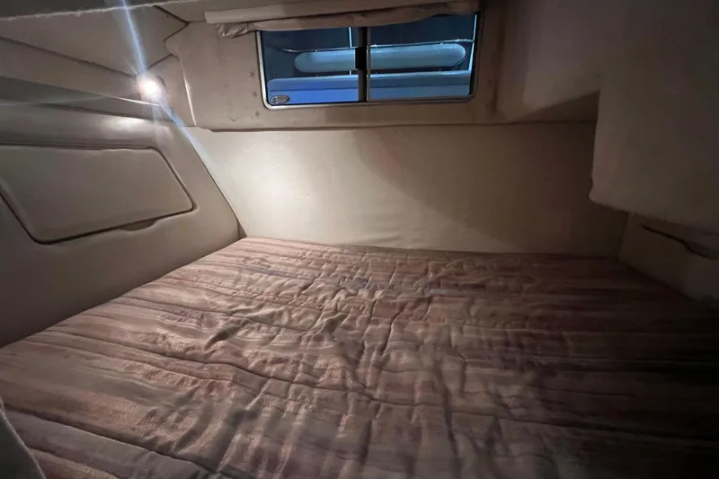 Slide: The Image of Cozy cabin interior of 1997 Maxum 2800 SCR boat with soft lighting. - 17