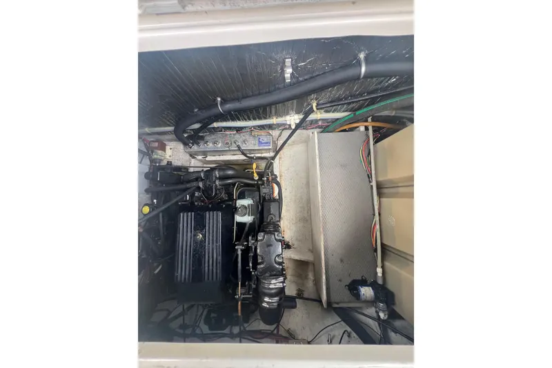 Slide: The Image of Engine compartment of a 1997 Maxum 2800 SCR boat, showing mechanical components and wiring. - 20