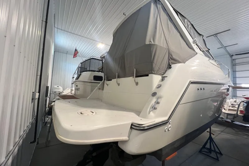 Slide: The Image of 1997 Maxum 2800 SCR boat in storage, covered and elevated on stands. - 4