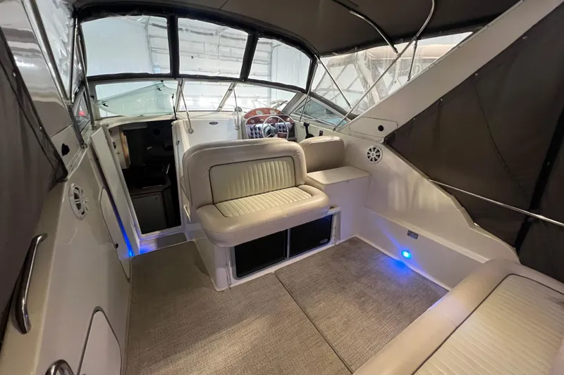 Slide: The Image of 1997 Maxum 2800 SCR boat interior with seating and helm, featuring modern design elements. - 7