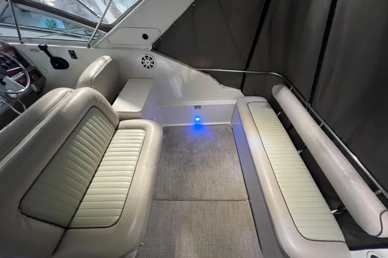 Slide: The Image of 1997 Maxum 2800 SCR boat interior with cushioned seating and modern design. - 8
