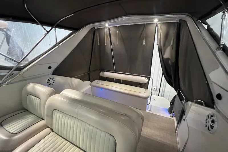 Slide: The Image of Interior of 1997 Maxum 2800 SCR boat with seating and curtains. - 9