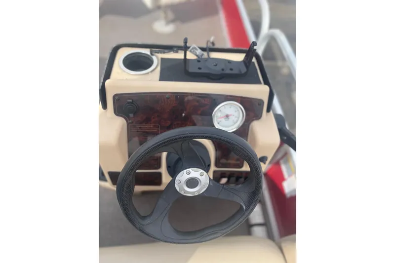 Slide: The Image of Steering console of 2015 SUNTRACKER BB16 boat with gauge and cup holder. - 4