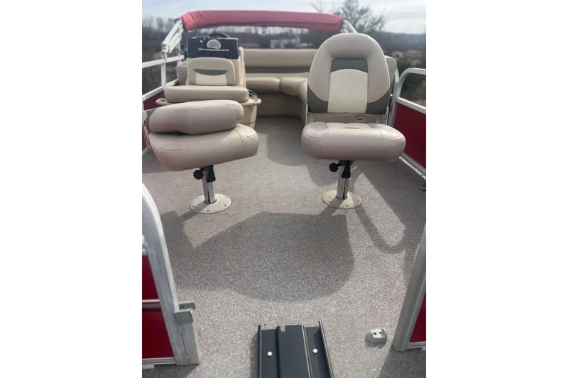 Slide: The Image of 2015 SUNTRACKER BB16 boat interior with beige seating and red accents. - 5
