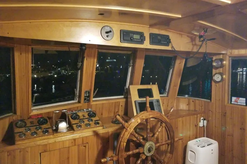 Slide: The Image of 1958 Stephens Brothers Naval Yard Patrol Craft helm with wooden wheel and vintage controls. - 10