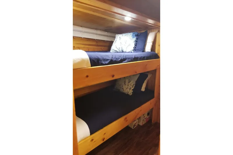 Slide: The Image of Bunk beds in 1958 Stephens Brothers Naval Yard Patrol Craft, featuring wooden frame and nautical decor. - 14