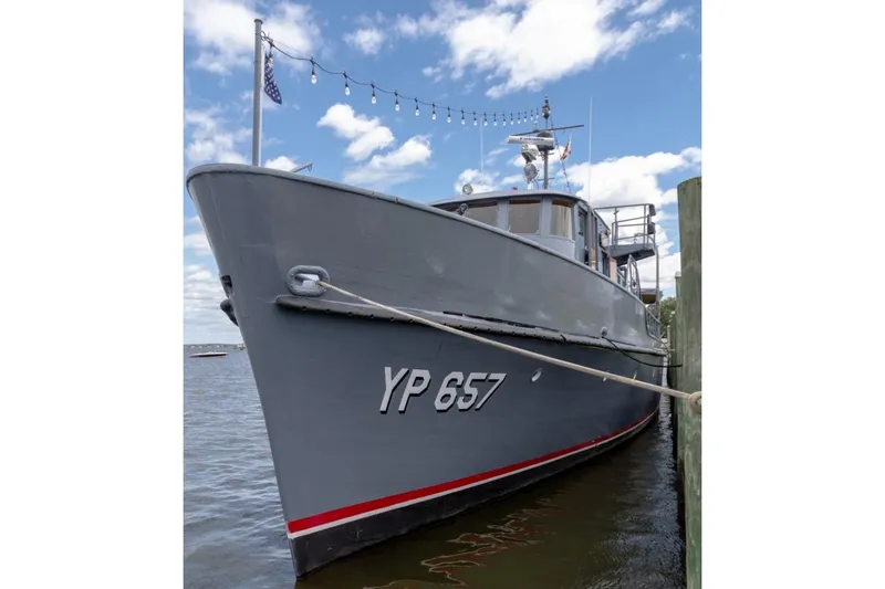 Slide: The Image of 1958 Stephens Brothers Naval Yard Patrol Craft YP 657 docked under a blue sky. - 6