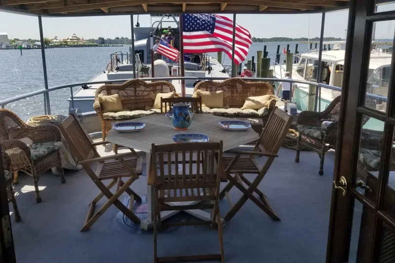 Slide: The Image of 1958 Stephens Brothers Naval Yard Patrol Craft with deck seating and American flag. - 7