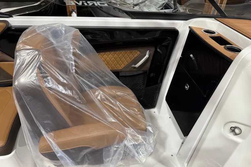 Slide: The Image of 2025 Yamaha Boats 252SD interior with brown leather seat and modern design elements. - 3