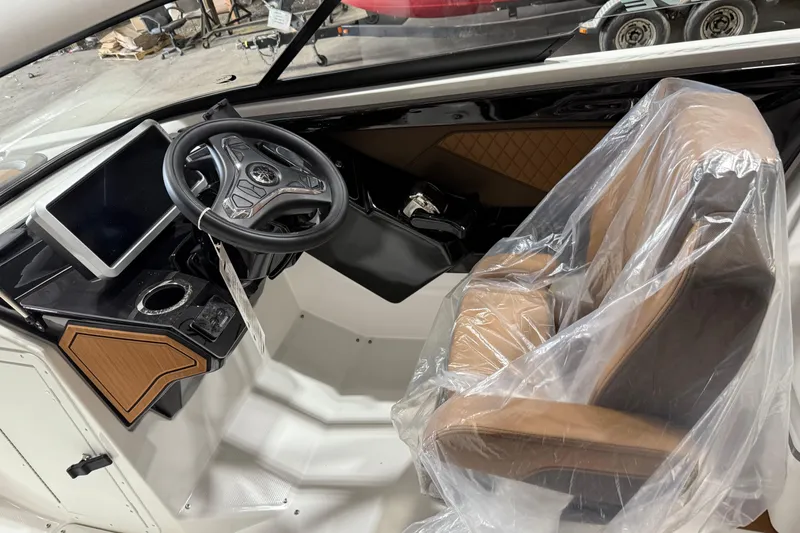 Slide: The Image of 2025 Yamaha Boats 252SD interior with steering wheel, touchscreen, and wrapped seat. - 4