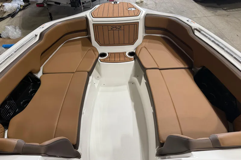 Slide: The Image of 2025 Yamaha Boats 252SD interior with tan seating and wood accents. - 5