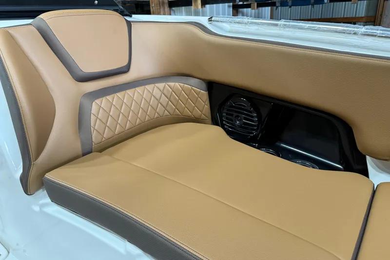 Slide: The Image of Luxurious tan seating in 2025 Yamaha Boats 252SD, featuring diamond stitching and integrated speaker. - 6
