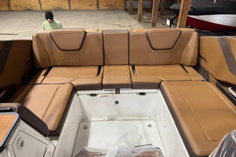 Slide: The Image of 2025 Yamaha Boats 252SD interior with luxurious brown seating and spacious layout. - 7