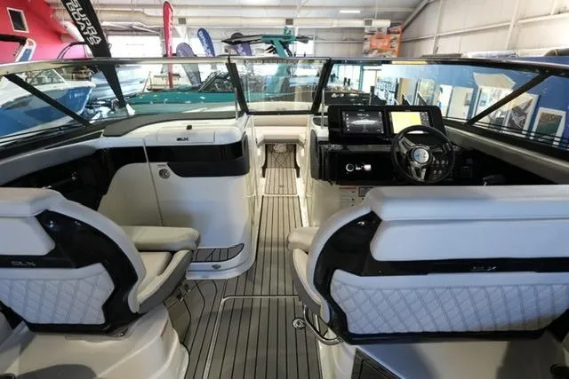 Slide: The Image of 2026 Sea Ray SLX 280 boat interior with modern dashboard and seating. - 17