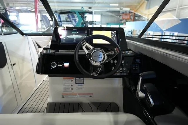 Slide: The Image of Interior view of 2026 Sea Ray SLX 280 boat cockpit with modern controls and steering wheel. - 18