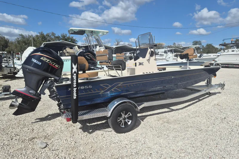 The Image of 2026 Xpress H20 boat with Yamaha engine on trailer, parked outdoors under blue sky. - 1