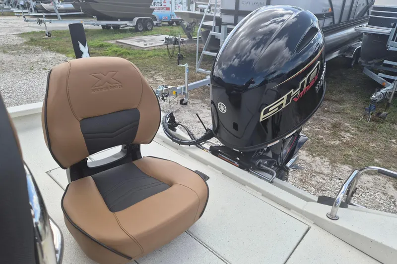 Slide: The Image of 2026 Xpress H20 boat seat and Yamaha outboard motor on display. - 11