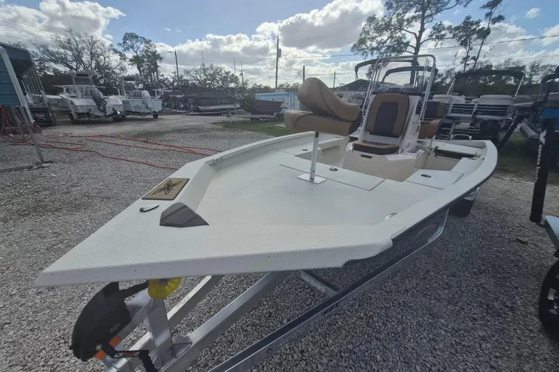 Slide: The Image of 2026 Xpress H20 boat on trailer, displayed outdoors under a partly cloudy sky. - 12