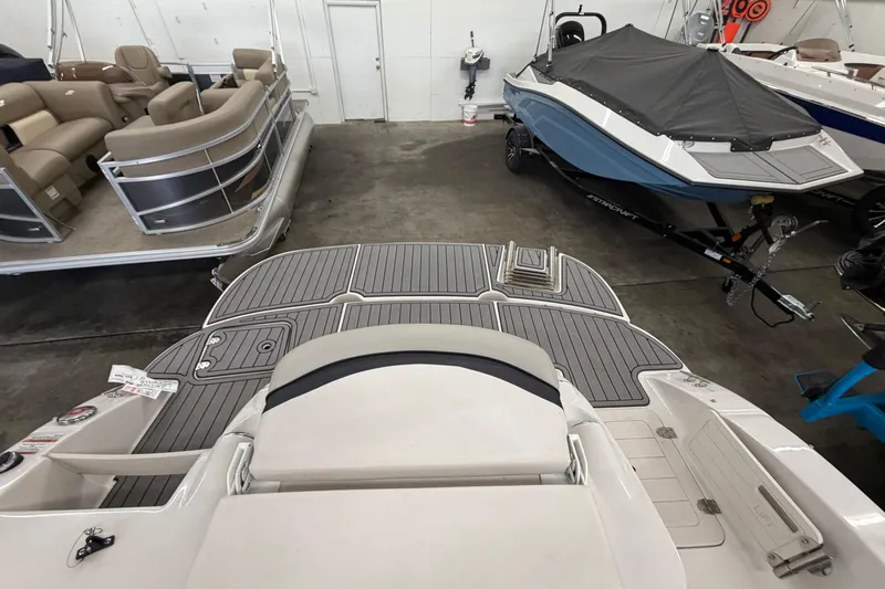 Slide: The Image of 2020 Starcraft 2000 IO Limited boat in showroom, featuring sleek design and spacious interior. - 4