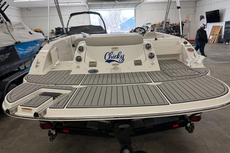 Slide: The Image of 2020 Starcraft 2000 IO Limited boat in showroom, featuring spacious deck and sleek design. - 6