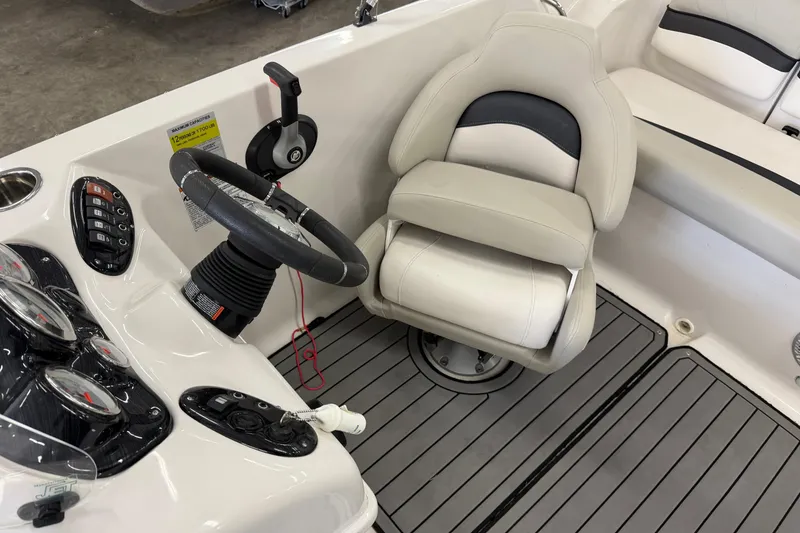Slide: The Image of 2020 Starcraft 2000 IO Limited boat interior with steering wheel and seating. - 9