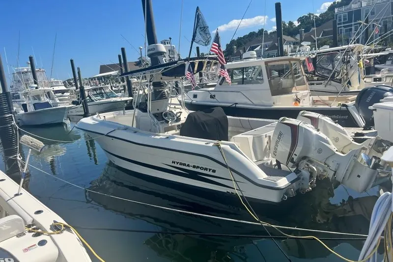 The Image of 2003 Hydra-Sports Vector 2600 CC boat docked in a marina, surrounded by other vessels. - 0