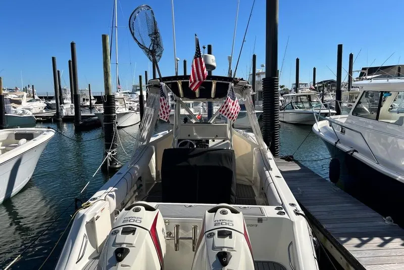 Slide: The Image of 2003 Hydra-Sports Vector 2600 CC docked at marina with twin engines and flags. - 1