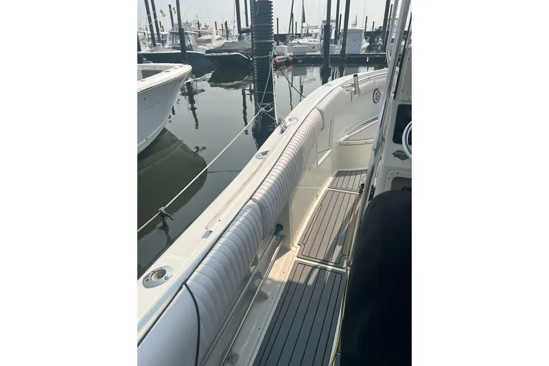 Slide: The Image of 2003 Hydra-Sports Vector 2600 CC boat docked, showcasing sleek deck design and marina setting. - 10