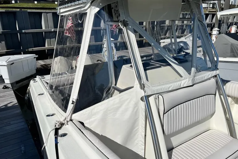 Slide: The Image of 2003 Hydra-Sports Vector 2600 CC boat with clear enclosure and cushioned seating. - 11