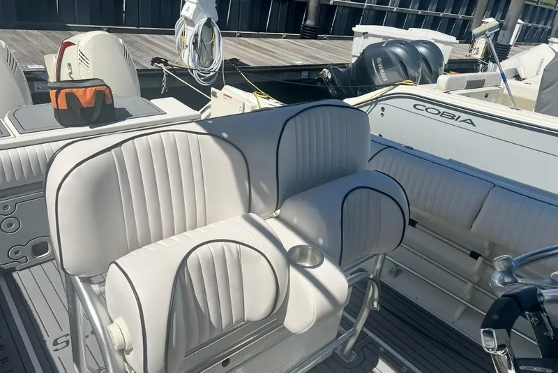 Slide: The Image of 2003 Hydra-Sports Vector 2600 CC boat interior with white seating and cup holder. - 7