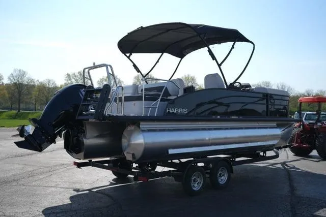 Slide: The Image of 2026 Harris Cruiser 210 pontoon boat on trailer, featuring a sleek black design and canopy. - 11