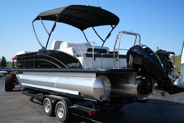 Slide: The Image of 2026 Harris Cruiser 210 pontoon boat on trailer, featuring sleek design and canopy. - 13