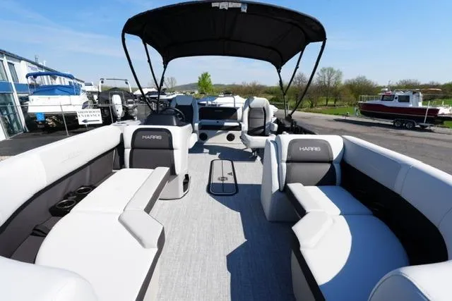 Slide: The Image of 2026 Harris Cruiser 210 pontoon boat with spacious seating and canopy, docked outdoors. - 14