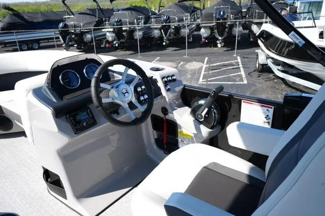 Slide: The Image of 2026 Harris Cruiser 210 boat cockpit with steering wheel and control panel. - 19