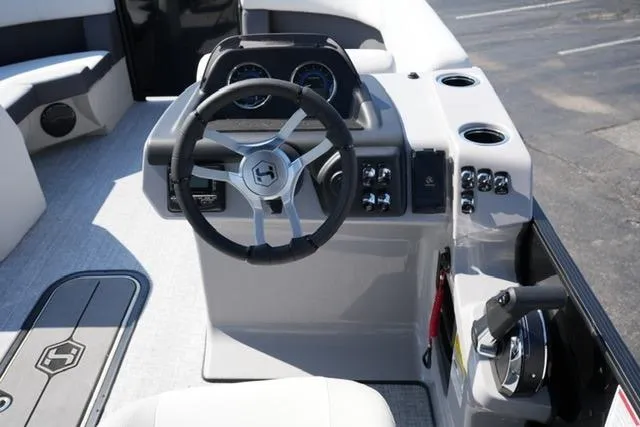 Slide: The Image of 2026 Harris Cruiser 210 boat dashboard with steering wheel and control panel. - 20