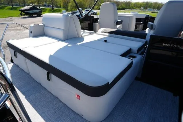 Slide: The Image of 2026 Harris Cruiser 210 boat with spacious white seating and modern design. - 23