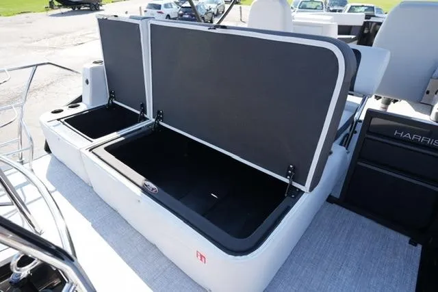 Slide: The Image of 2026 Harris Cruiser 210 boat with open storage compartments on deck. - 24