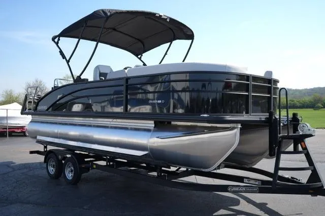 Slide: The Image of 2026 Harris Cruiser 210 pontoon boat on trailer, featuring sleek design and canopy. - 9