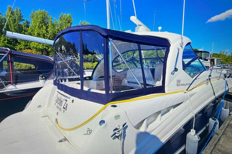 Slide: The Image of 2005 Sea Ray 390 Express Cruiser docked, featuring sleek design and clear canopy. - 1