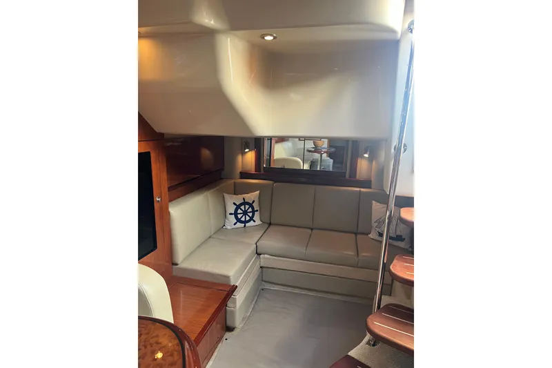 Slide: The Image of Interior of 2005 Sea Ray 390 Express Cruiser with beige seating and nautical decor. - 13