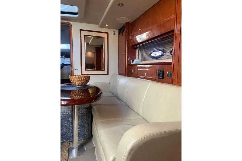 Slide: The Image of Interior of 2005 Sea Ray 390 Express Cruiser with beige seating and wooden accents. - 15