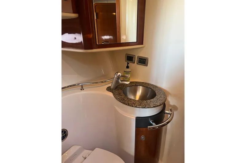 Slide: The Image of Bathroom sink area in 2005 Sea Ray 390 Express Cruiser with granite countertop. - 18