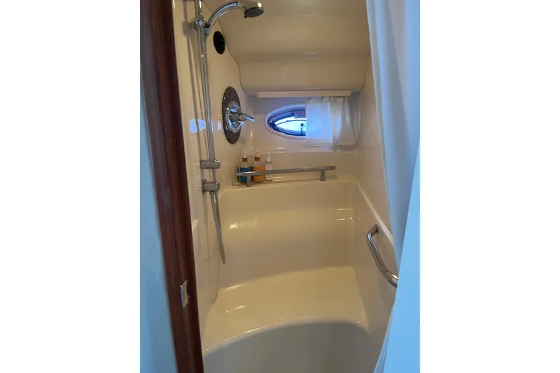 Slide: The Image of Shower area in 2005 Sea Ray 390 Express Cruiser with porthole and toiletries. - 19