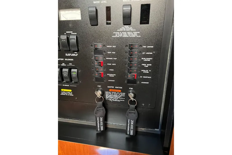 Slide: The Image of Control panel of a 2005 Sea Ray 390 Express Cruiser with switches and keys. - 21