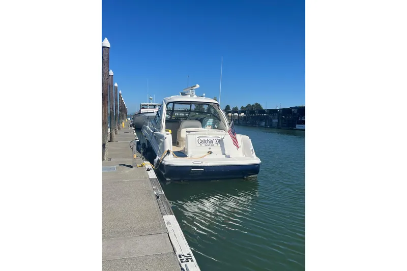 Slide: The Image of 2005 Sea Ray 390 Express Cruiser docked at marina under clear blue sky. - 3