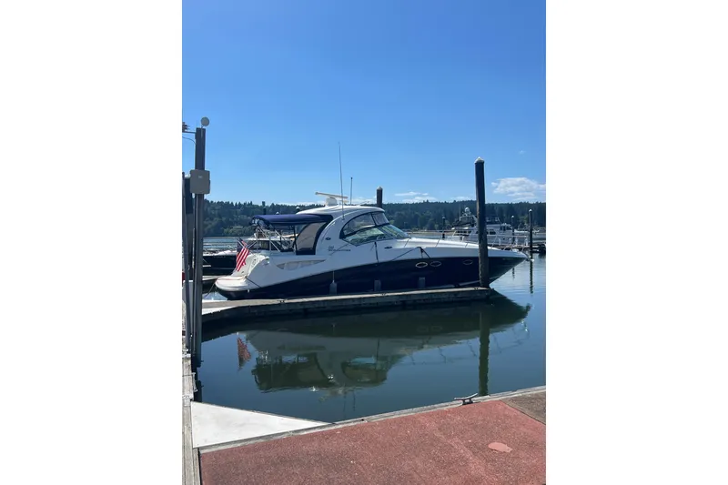 Slide: The Image of 2005 Sea Ray 390 Express Cruiser docked at marina under clear blue sky. - 4