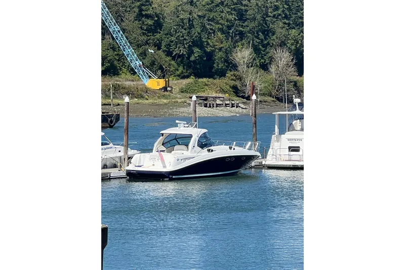 Slide: The Image of 2005 Sea Ray 390 Express Cruiser docked in a serene marina setting. - 5