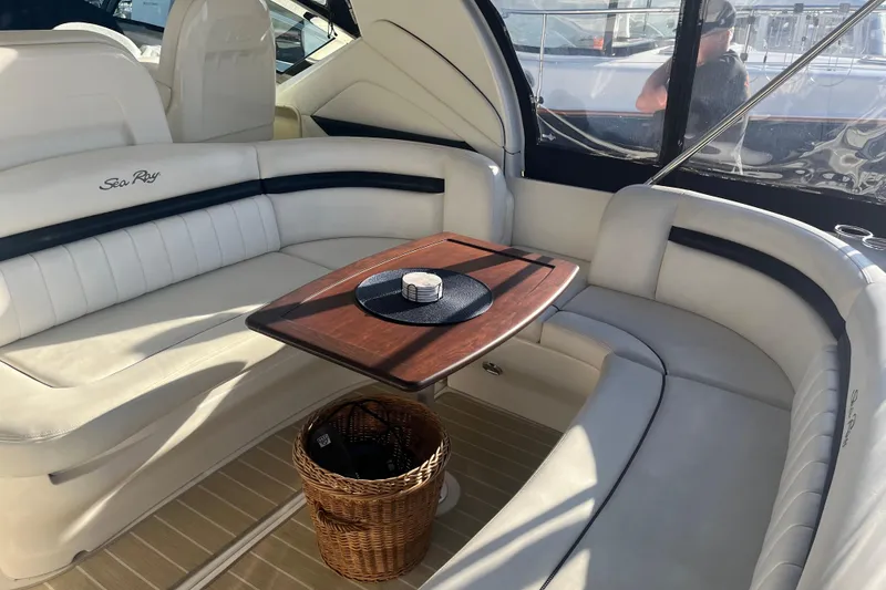 Slide: The Image of Luxurious 2005 Sea Ray 390 Express Cruiser interior with elegant seating and wooden table. - 7
